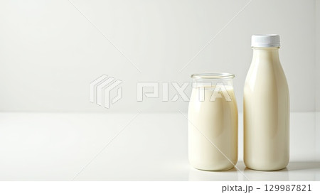 Fresh Milk Bottles on White Surface with Soft Lighting Fresh Milk Bottles on White Surface with Soft Lighting 129987821