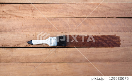 Paint brush and wood material in construction work. 129988076