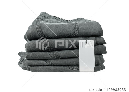 Dark gray denim jeans neatly arranged with price tag visible Dark gray denim jeans neatly arranged with price tag visible 129988088