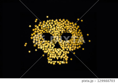 Symbol of gold glitter skull on dark black with sparkles. Halloween party concept. 129988703