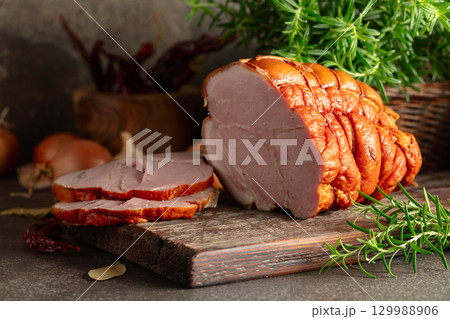 Smoked pork ham on a kitchen table. Smoked pork ham on a kitchen table. 129988906
