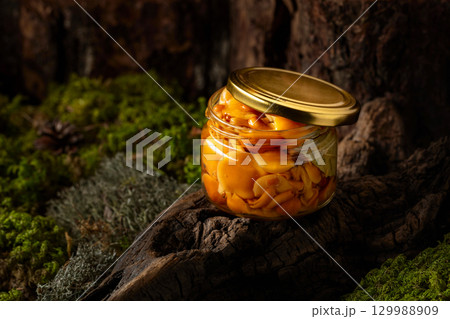 Homemade pickled honey mushrooms in a glass jar. 129988909
