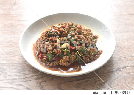 spicy stir fried chop beef meat with chili and basil on plate spicy stir fried chop beef meat with chili and basil on plate 129988998