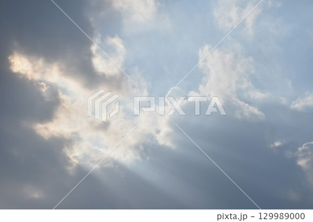 sunlight spreading from dark rain cloud floating on sky in afternoon sunlight spreading from dark rain cloud floating on sky in afternoon 129989000