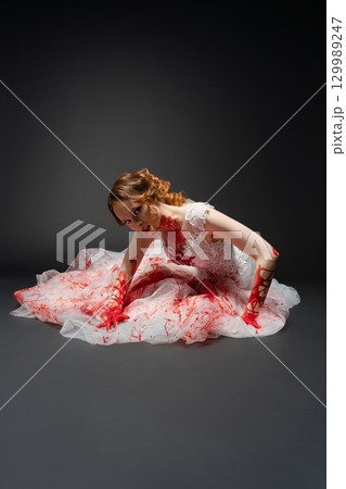 Bridal beauty with a katana amidst a dramatic depiction of murder and blood 129989247