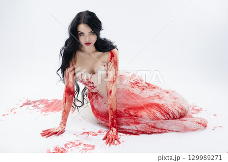 Dark beauty in blood-soaked bridal lingerie with a knife Dark beauty in blood-soaked bridal lingerie with a knife 129989271