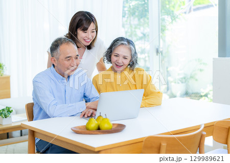 リビングでパソコンを見る親子 129989621