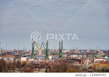 Port cranes and shipyard in industrial harbor city. Port cranes and shipyard in industrial harbor city. 129989705
