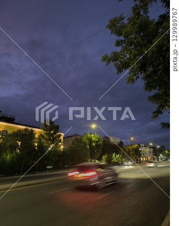 City at Night Urban Landscape of Cars Streaking Through the Evening with a Dramatic Sky City at Night Urban Landscape of Cars Streaking Through the Evening with a Dramatic Sky 129989767