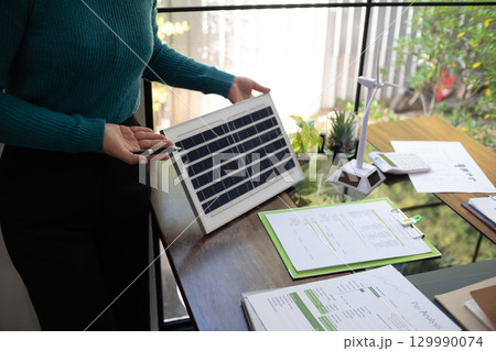 A sales representative presenting solar and wind power, alternative energy, clean energy for future. 129990074