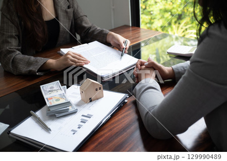 Real estate agent presenting and approved home loan contract. Real estate investment, Home mortgage concept. 129990489