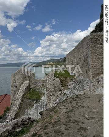 Golubac Fortress (Golubacka trvdjava, or Goluback Grad) taken during a sunny afternoon with windmills in background. The Golubac Castle was a medieval fortified town on the Danube River in Serbia Golubac Fortress (Golubacka trvdjava, or Goluback Grad) taken during a sunny afternoon with windmills in background. The Golubac Castle was a medieval fortified town on the Danube River in Serbia 129990704