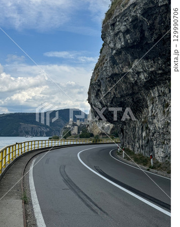 View of the highway and cliffs. The Golubac Castle was a medieval fortified town on the Danube River in Serbia 129990706