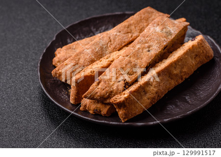 Biscotti or cantuccini biscuits, a crispy sweet Italian pastry. Biscotti dessert Biscotti or cantuccini biscuits, a crispy sweet Italian pastry. Biscotti dessert 129991517