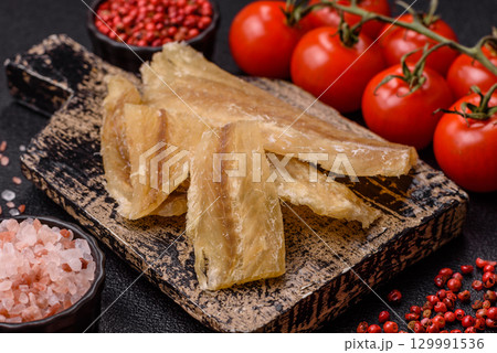 Dried salted fish, snacks or jerky, slices of white fish fillets Dried salted fish, snacks or jerky, slices of white fish fillets 129991536