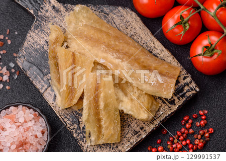 Dried salted fish, snacks or jerky, slices of white fish fillets Dried salted fish, snacks or jerky, slices of white fish fillets 129991537