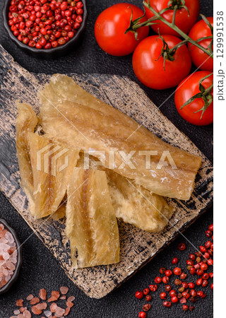 Dried salted fish, snacks or jerky, slices of white fish fillets Dried salted fish, snacks or jerky, slices of white fish fillets 129991538