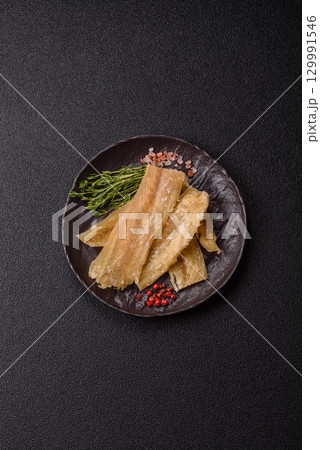 Dried salted fish, snacks or jerky, slices of white fish fillets Dried salted fish, snacks or jerky, slices of white fish fillets 129991546