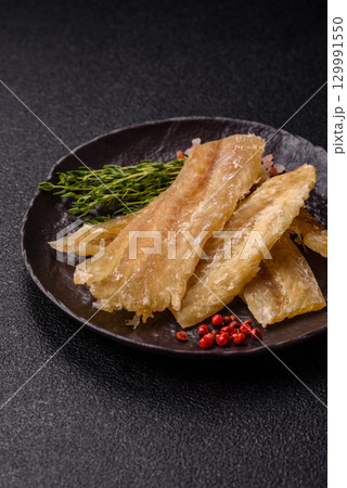 Dried salted fish, snacks or jerky, slices of white fish fillets Dried salted fish, snacks or jerky, slices of white fish fillets 129991550