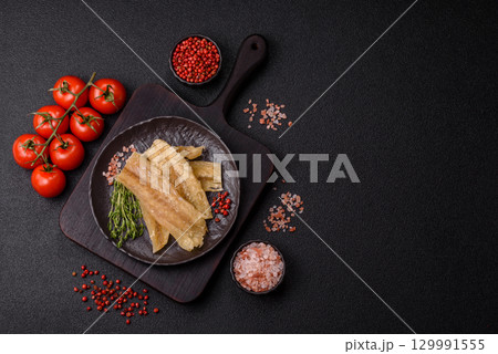 Dried salted fish, snacks or jerky, slices of white fish fillets Dried salted fish, snacks or jerky, slices of white fish fillets 129991555