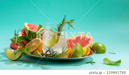 Refreshing summer drink with ice, citrus, rosemary and mint. Refreshing summer drink with ice, citrus, rosemary and mint. 129991788