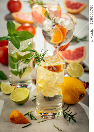 Refreshing summer cocktails with citrus on a white marble table. 129991790
