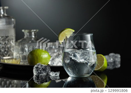 Vodka in a glass with ice. Vodka in a glass with ice. 129991806