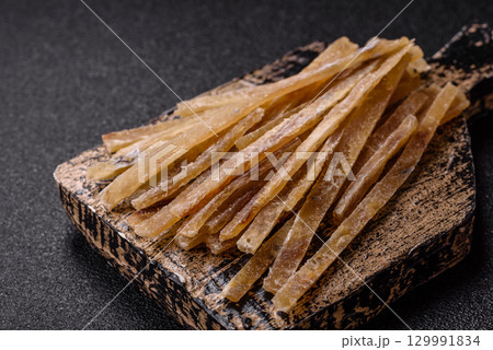 Food, snacks or jerky made from dried dehydrated salted fish with spices. Snacks fish 129991834