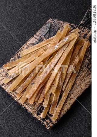 Food, snacks or jerky made from dried dehydrated salted fish with spices. Snacks fish 129991836