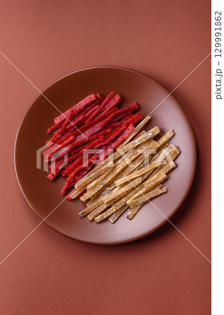 A set of jerky or snacks of chicken and fish with salt and spices 129991862