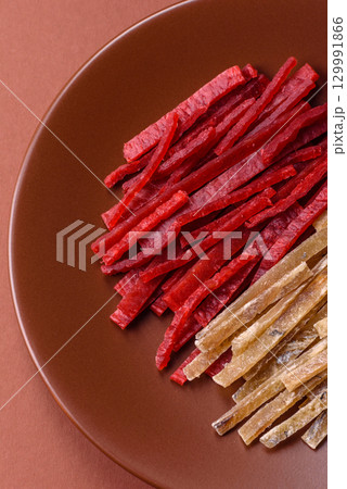 A set of jerky or snacks of chicken and fish with salt and spices A set of jerky or snacks of chicken and fish with salt and spices 129991866