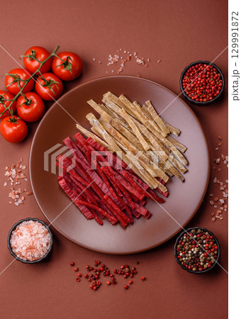 A set of jerky or snacks of chicken and fish with salt and spices A set of jerky or snacks of chicken and fish with salt and spices 129991872