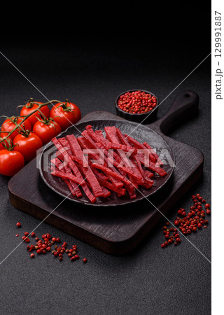 Jerky or dried chicken and cherry snacks. Dehydrated, dried snacks for beer 129991887