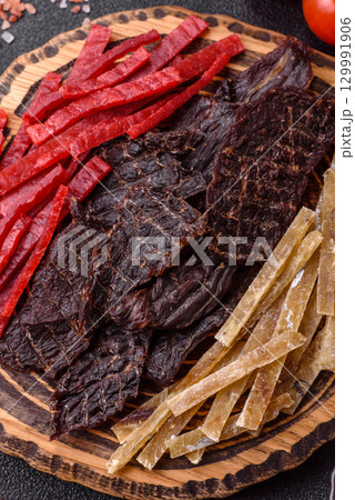 A set of jerky or snacks of beef, chicken and fish with salt and spices A set of jerky or snacks of beef, chicken and fish with salt and spices 129991906