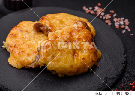 Steak, a pork or chicken chop covered with melted cheese. Grilled meat Steak, a pork or chicken chop covered with melted cheese. Grilled meat 129991989