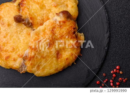 Steak, a pork or chicken chop covered with melted cheese. Grilled meat Steak, a pork or chicken chop covered with melted cheese. Grilled meat 129991990