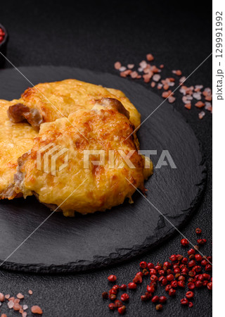 Steak, a pork or chicken chop covered with melted cheese. Grilled meat 129991992