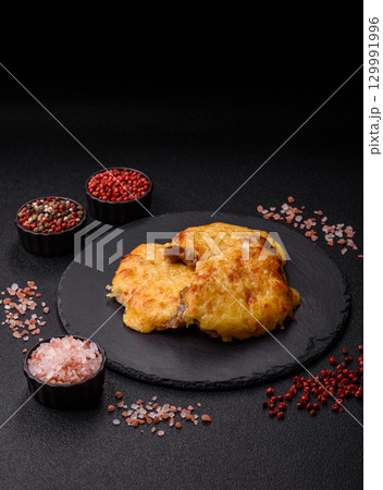 Steak, a pork or chicken chop covered with melted cheese. Grilled meat Steak, a pork or chicken chop covered with melted cheese. Grilled meat 129991996