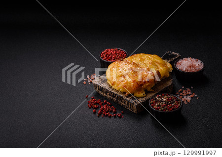 Steak, a pork or chicken chop covered with melted cheese. Grilled meat 129991997