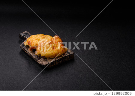 Steak, a pork or chicken chop covered with melted cheese. Grilled meat Steak, a pork or chicken chop covered with melted cheese. Grilled meat 129992009