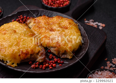 Steak, a pork or chicken chop covered with melted cheese. Grilled meat Steak, a pork or chicken chop covered with melted cheese. Grilled meat 129992021