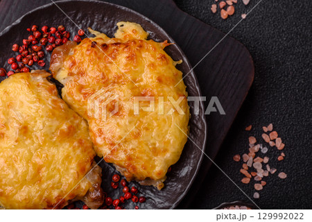 Steak, a pork or chicken chop covered with melted cheese. Grilled meat Steak, a pork or chicken chop covered with melted cheese. Grilled meat 129992022
