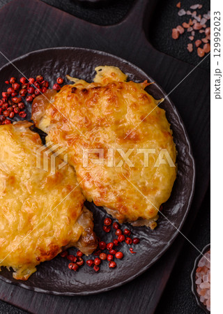 Steak, a pork or chicken chop covered with melted cheese. Grilled meat Steak, a pork or chicken chop covered with melted cheese. Grilled meat 129992023