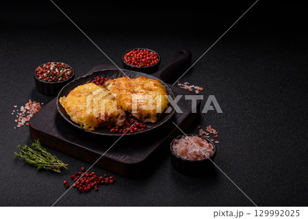 Steak, a pork or chicken chop covered with melted cheese. Grilled meat 129992025
