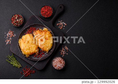 Steak, a pork or chicken chop covered with melted cheese. Grilled meat Steak, a pork or chicken chop covered with melted cheese. Grilled meat 129992026