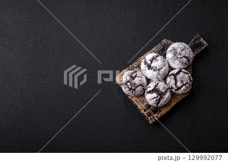 Chocolate crinkle cookies sprinkled with powdered sugar, homemade baking 129992077