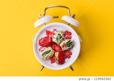 Christmas, gingerbread or madeleine on a plate on a vintage clock. Christmas conceptual background 129992082
