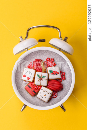 Christmas, gingerbread or madeleine on a plate on a vintage clock. Christmas conceptual background 129992088