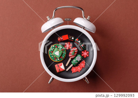 Christmas, eclair on a plate on a vintage clock. Christmas time conceptual background 129992093