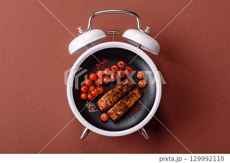 Red salmon fish grilled with pepper and spices. Concept time to eat fish 129992110
